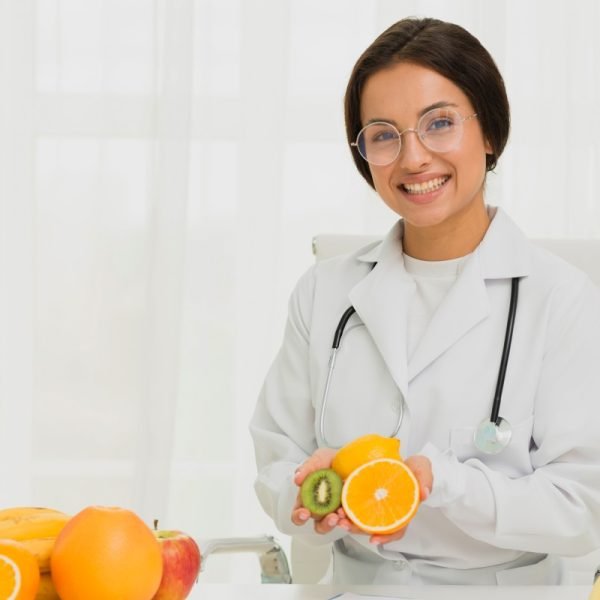 medium-shot-happy-doctor-with-orange-kiwi-2-600x600